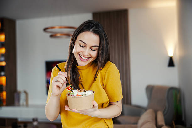 Person enjoying a mindful meal with fresh vegetables