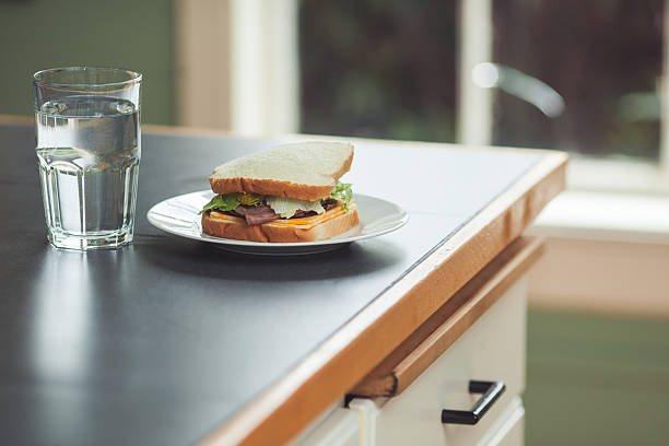 Fresh wholegrain bread and seasonal vegetables on a kitchen counter
